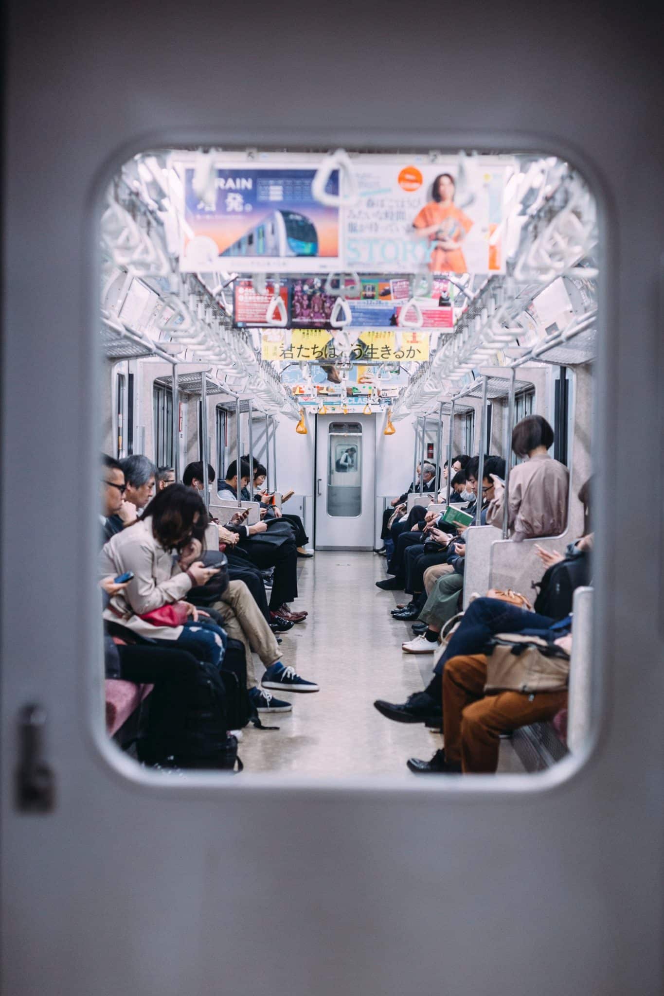 Photo of Japanese people on a train by Liam Burnett-Blue for Unsplash