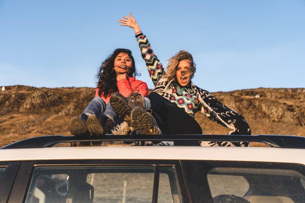 Photo of women on top of car by Raphael Rychetsky for Unsplash
